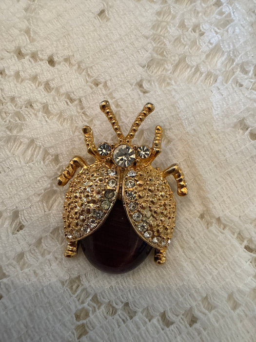 Gold toned ladybug pin with rhinestones
