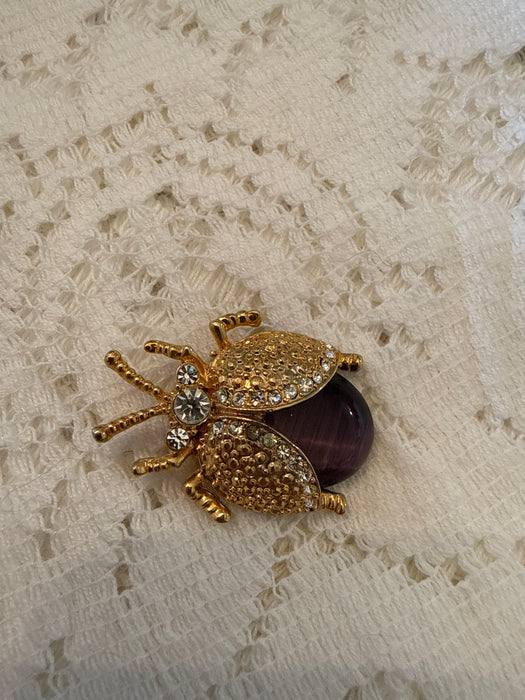 Gold toned ladybug pin with rhinestones