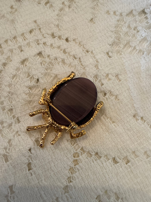 Gold toned ladybug pin with rhinestones