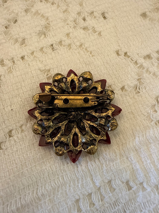 Red floral pin with colored stones