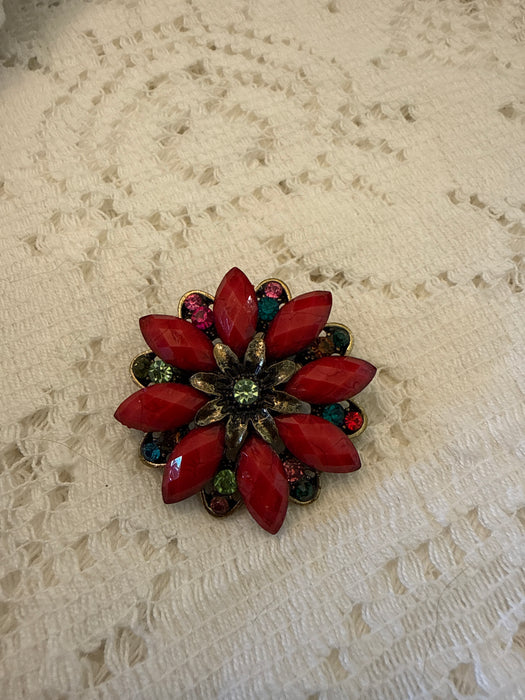Red floral pin with colored stones